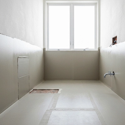 Waterproofing materials being applied in a bathroom